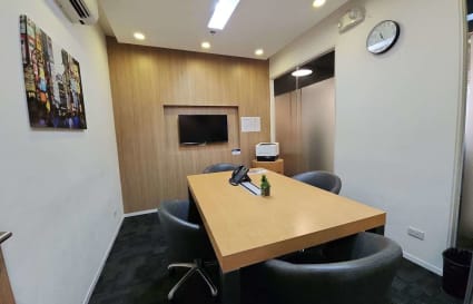 Sleek meeting room with modern amenities and stylish decor in a vibrant coworking space.