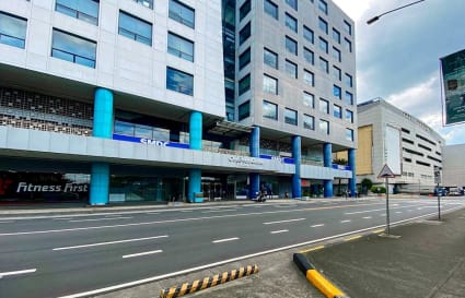 Modern office building with a sleek facade, ample natural light, and convenient location.