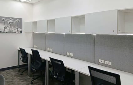 Modern coworking space with sleek workstations and ample storage. Ideal for productivity.