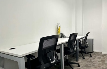 Modern office space with ergonomic chairs and sleek desks, perfect for focused work.