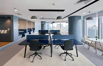Bright, open-plan office with modern desks, ample lighting, and city views. Ideal for productivity.
