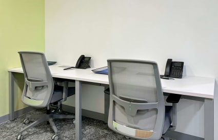Modern coworking space with ergonomic chairs and individual workstations. Perfect for focused productivity.