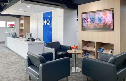 Modern lobby with plush seating, digital display, and welcoming reception. Ideal for clients.
