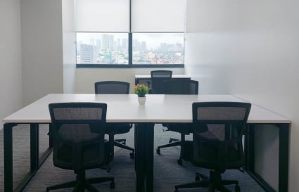 Bright workspace with modern desks, ergonomic chairs, and a stunning city view. Ideal for collaboration.