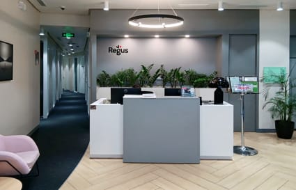 Modern reception area with sleek design, inviting lounge seating, and lush greenery.