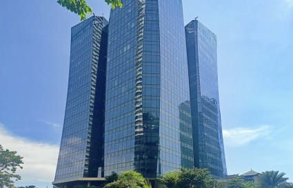 Modern coworking space in Estrella, Metro Manila, within a sleek, glass-façade skyscraper.