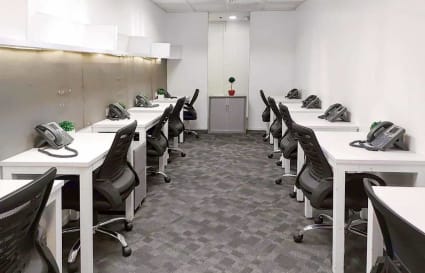 Modern coworking space with ergonomic chairs and organized workstations for productivity.