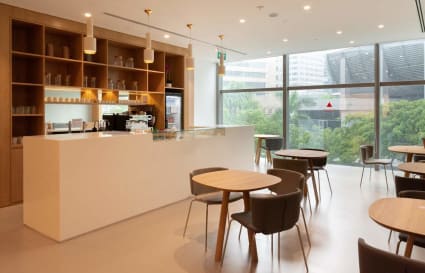 Bright coworking space with modern furnishings, a sleek coffee bar, and city views in Somerset Road.