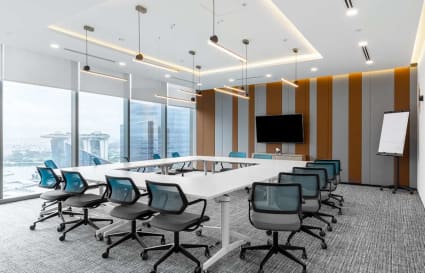 Modern coworking space with stunning Marina Bay views, sleek furniture, and ample natural light.