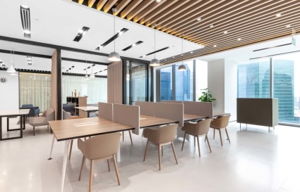Modern coworking space with open desks, abundant natural light, and stylish decor at Marina View.