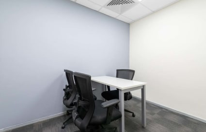 Modern coworking space with ergonomic chairs and versatile meeting table on JNTU Road.