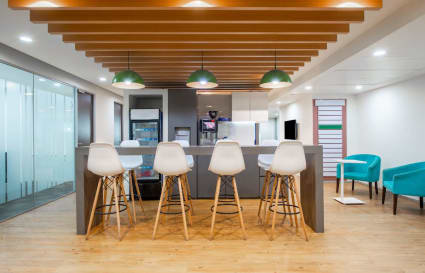 Modern coworking space with sleek seating, ample lighting, and a communal bar area on JNTU Road.