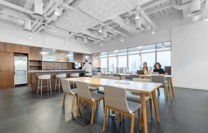 Modern coworking space with natural light, open layout, and sleek kitchen area on Hennessy Road.