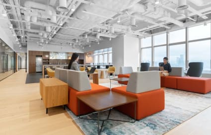 Bright, modern coworking space with open layout, stylish seating, and abundant natural light.