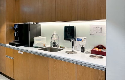 Modern kitchenette with stylish wood cabinets in a flexible coworking space on Hennessy Road.