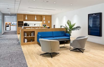Modern coworking area with sleek seating, ample natural light, and a welcoming atmosphere.
