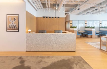 Modern coworking space with sleek reception, open layout, and private booths in Austin Road West.