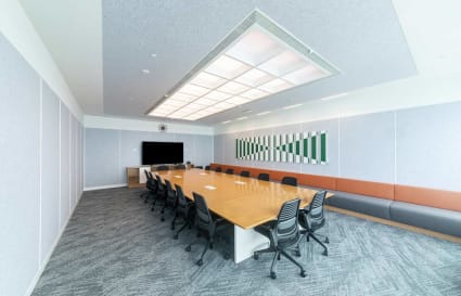 Spacious meeting room with modern decor and ample seating in a flexible coworking space.