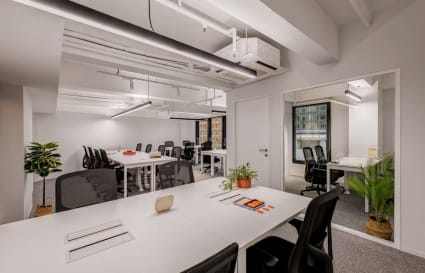 Modern coworking space with abundant natural light and sleek, ergonomic furniture. Ideal for productivity.