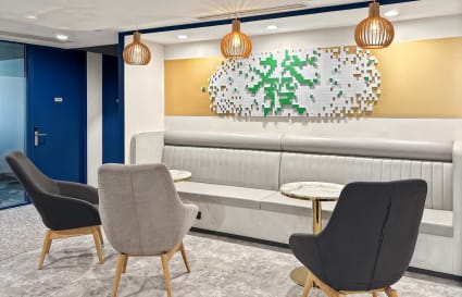 Modern coworking lounge with stylish seating and warm lighting on Prince Edward Road West.