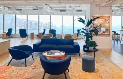 Modern coworking space with skyline views, cozy seating, and bright natural light on Canton Road.
