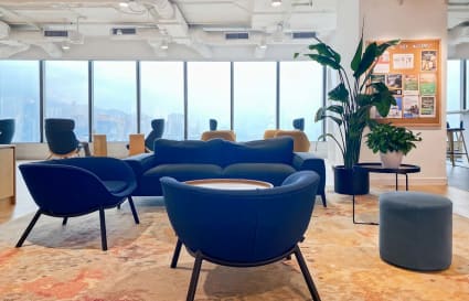 Modern coworking space on Canton Road with plush seating, natural light, and city views.