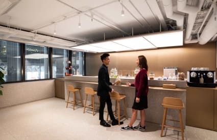 Sleek coworking lounge with modern seating and ample natural light on Connaught Road Central.