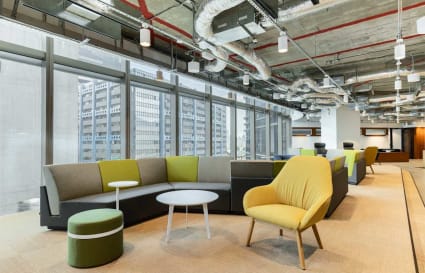 Bright coworking space with modern furnishings and panoramic city views on Hoi Bun Road.