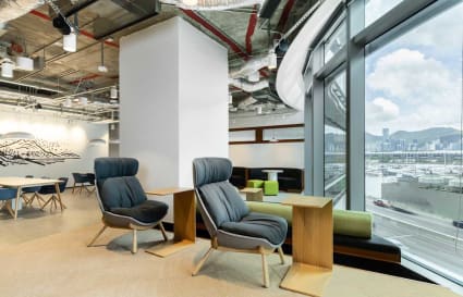 Modern coworking space with plush seating and stunning harbor views on Hoi Bun Road.