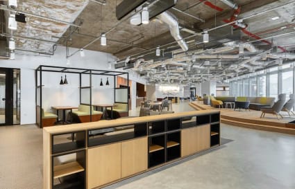Modern coworking space with open layout, cozy booths, and ample natural light.