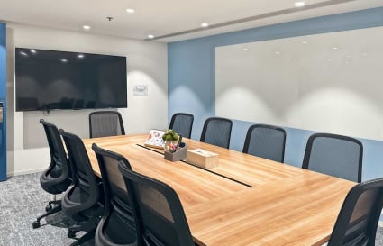 Modern conference room with smart TV, whiteboard, and sleek furnishings in Nathan Road coworking space.