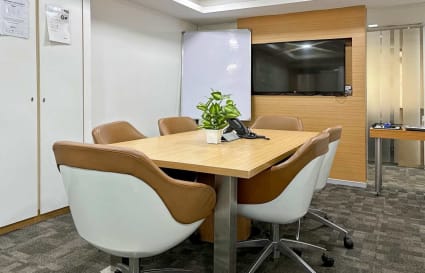 Modern Delhi coworking space with a sleek conference area, comfortable seating, and bright lighting.