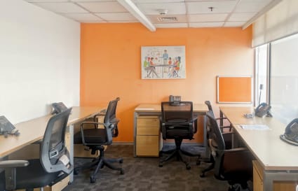 Bright, modern coworking office with ergonomic chairs and ample natural light in New Delhi.