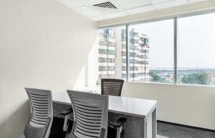 Bright, modern workspace with natural light and city view, ideal for focused productivity.