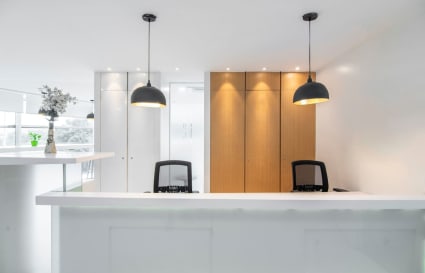 Modern coworking space with sleek design, ample lighting, and a welcoming reception area.