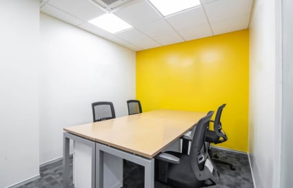 Bright, modern workspace with vibrant accent wall and ergonomic chairs in Lane Number 7, Maharashtra.