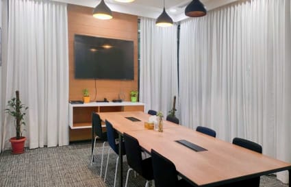 Modern conference room with natural light, sleek design, and state-of-the-art amenities.