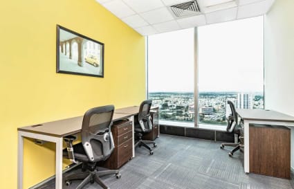 Bright, flexible workspace with city views, modern desks, and ergonomic seating.