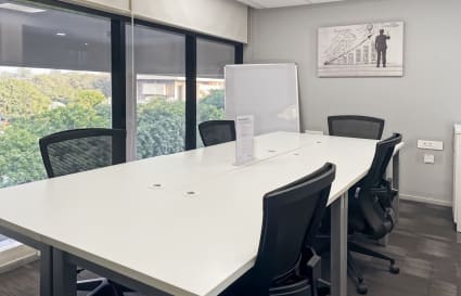 Bright coworking area with large windows, modern furnishings, and a scenic view in Sector 17A.