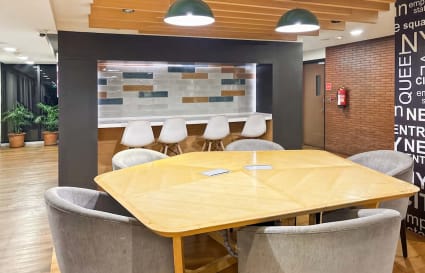 Modern coworking space with sleek wood finishes, stylish seating, and vibrant lighting in Sector 17A.
