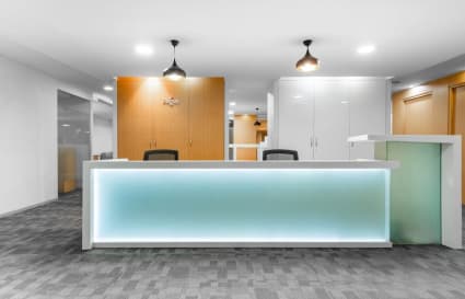 Modern reception area with sleek design, ample lighting, and contemporary furnishings. Ideal for welcoming clients.