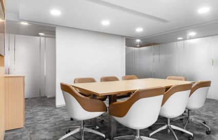 Modern conference room with sleek chairs and a spacious table, ideal for productive meetings.