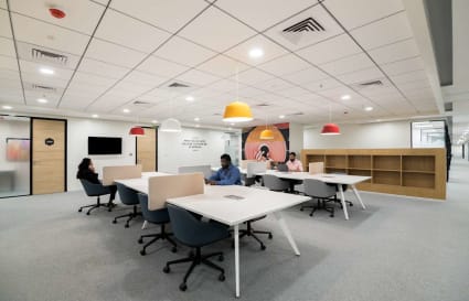 Modern coworking space with open plan, vibrant lighting, and ergonomic seating in JP Road, Maharashtra.