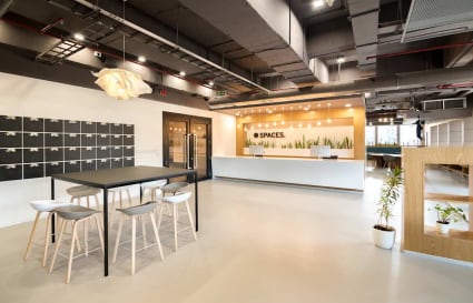 Modern coworking space with open layout, sleek furniture, and ample natural light on JP Road.