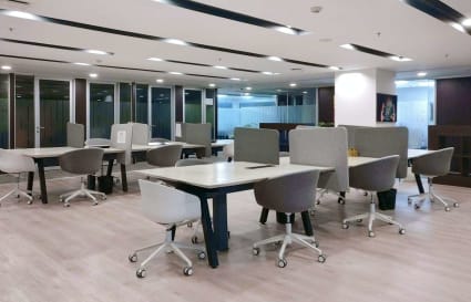 Modern Gurugram coworking space with open layout, stylish desks, and ample natural light.