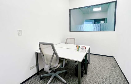 Modern private office with natural light and ergonomic chairs on 5th Avenue, Metro Manila.