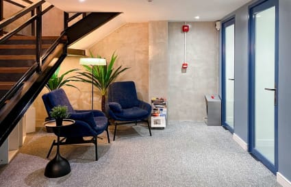 Stylish coworking nook with cozy seating, modern decor, and vibrant lighting on Quezon Ave.