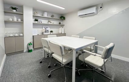 Modern coworking space with sleek furnishings, natural accents, and ample lighting in Quezon Avenue.