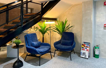 Cozy coworking lounge with plush seating and ample lighting on Quezon Avenue. Perfect for meetings.