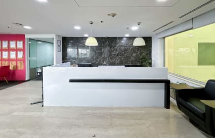 Modern coworking space in Mandir Marg featuring sleek reception and ample natural light.